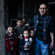 Mahmoud Ali* (whose name has been changed to protect his identity) stands in the entryway to his house in Qayyarah. Oil fires burned outside his home for months.
